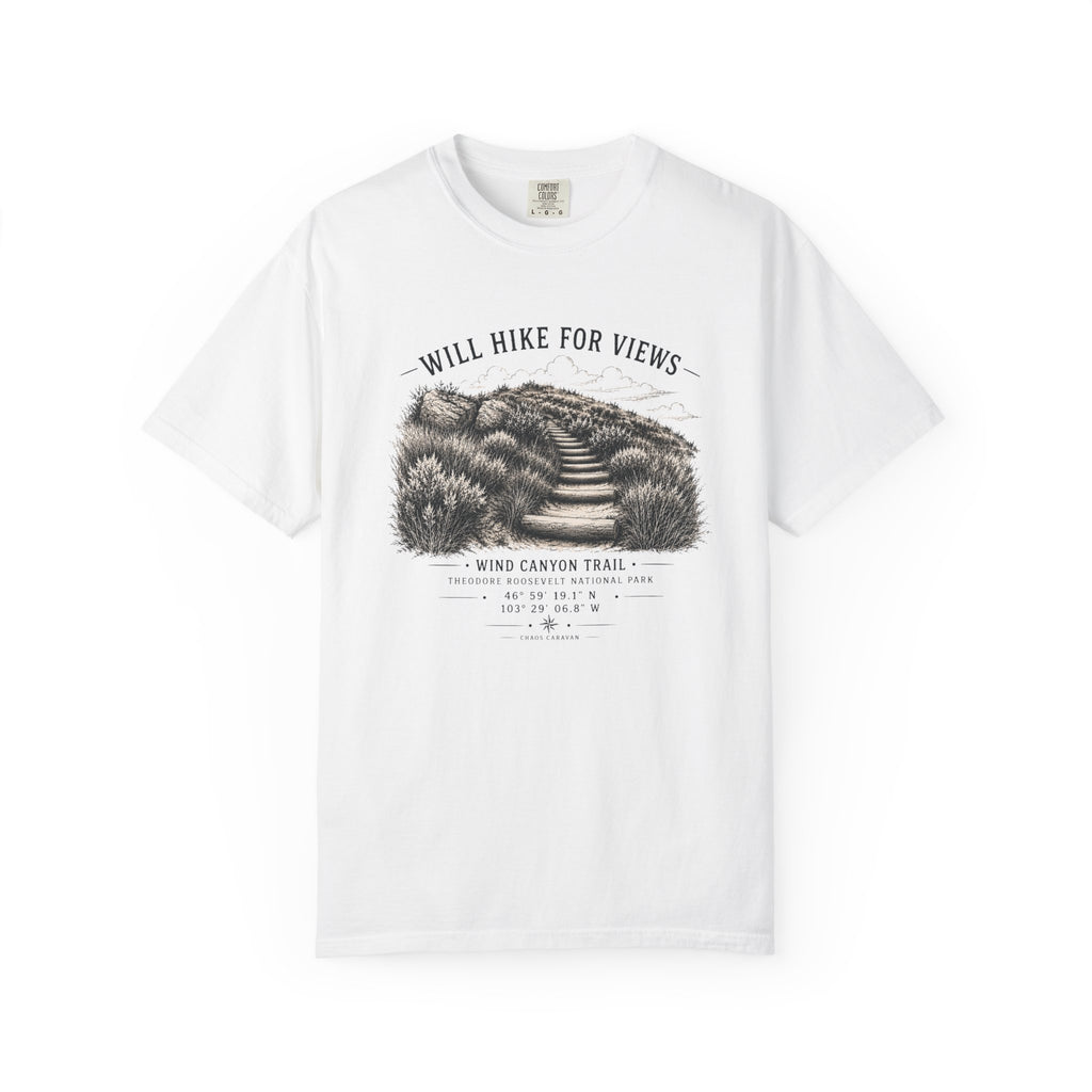 A white short-sleeve crewneck t-shirt featuring a black and white graphic print of a hiking trail on the front, with the text 'WILL HIKE FOR VIEWS' and 'WIND CANYON TRAIL'.