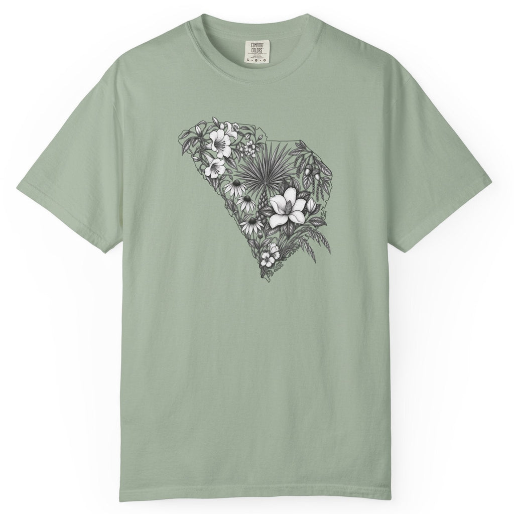 A sage green short-sleeve crewneck t-shirt featuring a black and white floral South Carolina graphic on the chest, displayed flat against a solid white background.