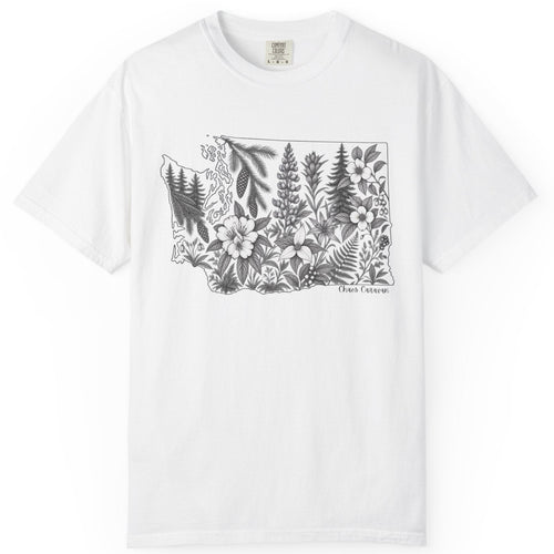 A white short-sleeve crewneck t-shirt featuring a black line art graphic of the state outline of Washington filled with botanical illustrations and the text 'chaos caravan' below, displayed on a clean white background.