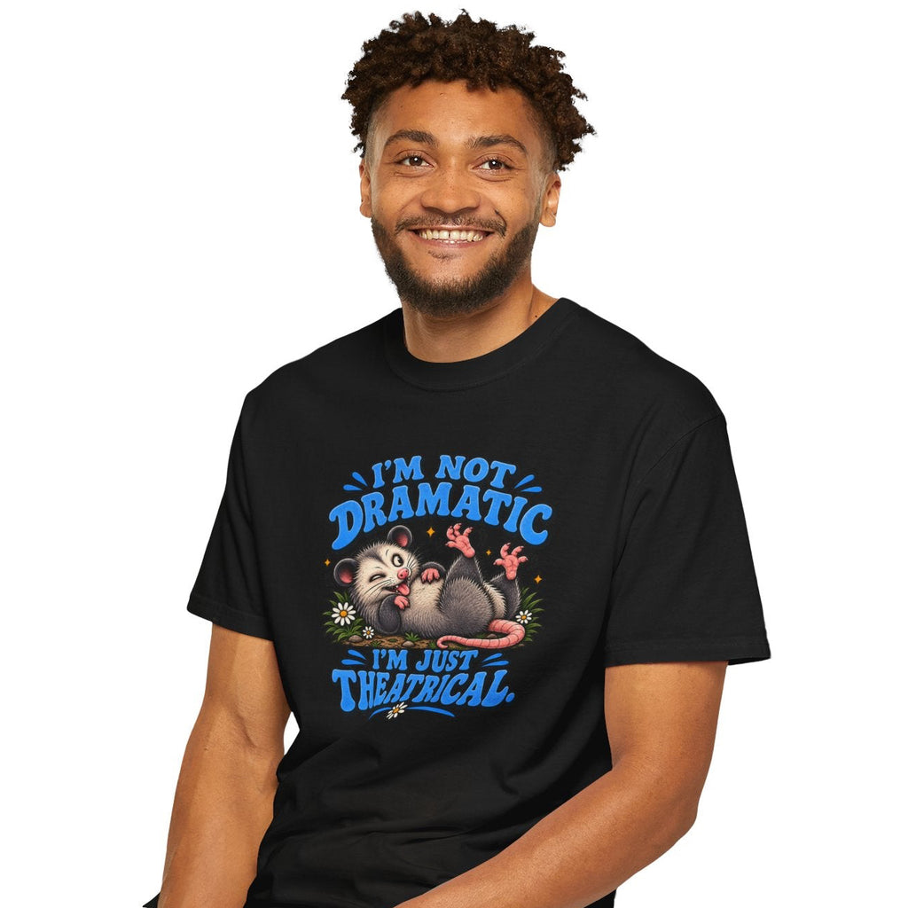 Man wearing a black t-shirt with a graphic design and text, sitting on a stool against a white background