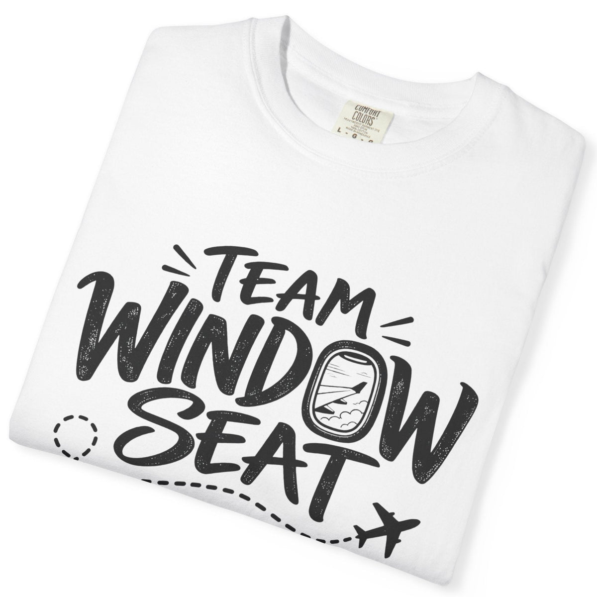 A folded white crewneck t-shirt with a black graphic print that reads 'TEAM WINDOW SEAT' with a stylized airplane window and small airplane icon.