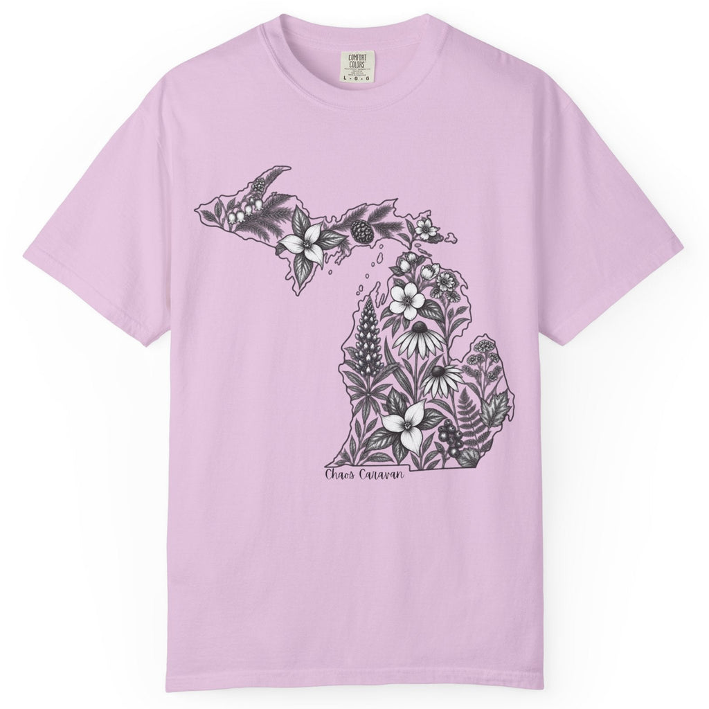 A light purple short-sleeve crewneck t-shirt featuring a black and white graphic of the state of Michigan filled with floral and botanical illustrations, displayed on a clean white background.