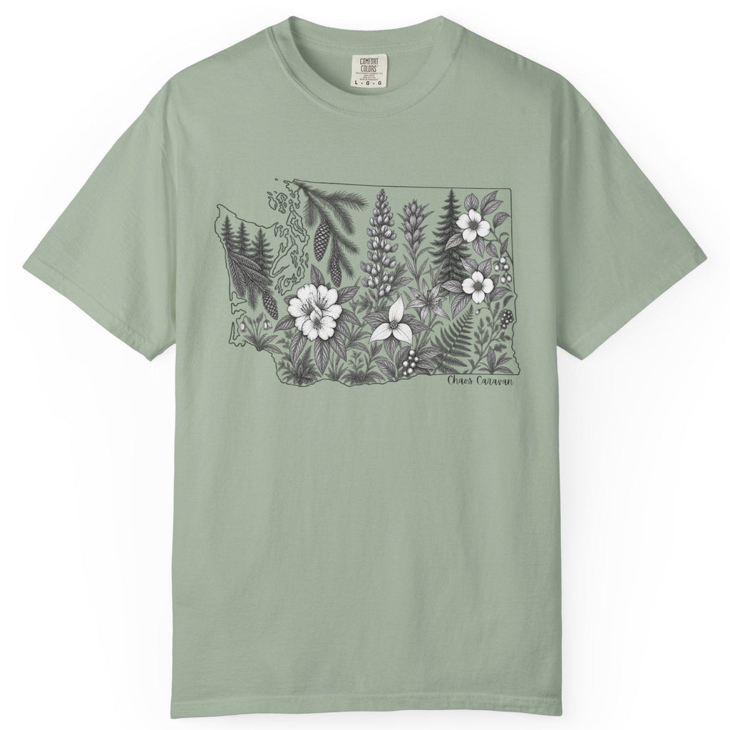 A sage green short-sleeve crewneck t-shirt featuring a black and white botanical illustration of the state of Washington filled with wildflowers on the chest, displayed against a clean white background.