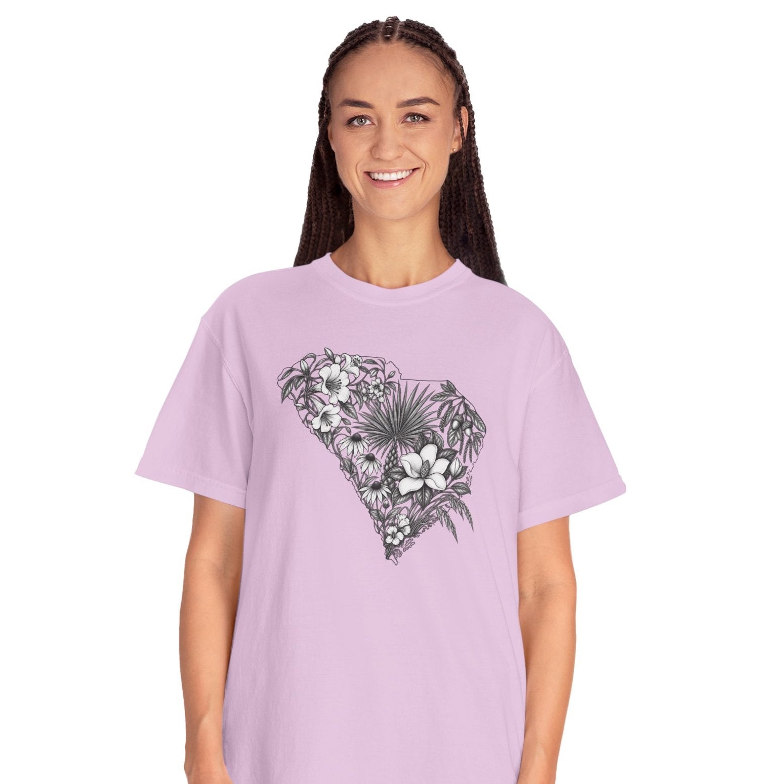 A woman modeling a light purple short-sleeve t-shirt with a black and white tropical floral graphic on the chest, paired with light blue jeans, against a plain white background.