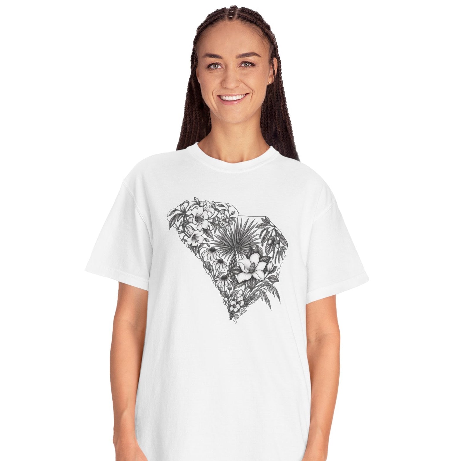 A woman modeling a white short-sleeve crewneck t-shirt with a black tropical floral heart graphic on the front, paired with light blue jeans, against a plain white background.